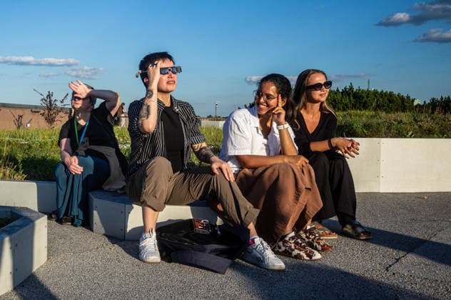 Polish Prime Minister, Donald Tusk joins observers to watch partial solar eclipse in Warsaw, Poland - 12 AUG 2026. A group of young people seen looking at the sun through filtered spectacles before the beginning of the solar eclipse. On the evening of the 12th August, Prime Minister of the Republic of Poland, Donald Tusk, joins scientific observers and members of the public at the Copernicus Science Centre in Warsaw to watch a partial solar eclipse. At its maximum, the Moon obscures about 82% of the Sun as viewed from the Polish capital. Warsaw’s eclipse runs from approximately 19:14 until sunset at 20:06, reaching its maximum at 20:02. The roughly 82% figure refers to the Sun’s covered area; the eclipse magnitude was about 0.85. Warsaw Po Copyright: xNeilxMiltonx xSOPAxImagesx NSM2026168G0812-L1003162_5000_300dpi