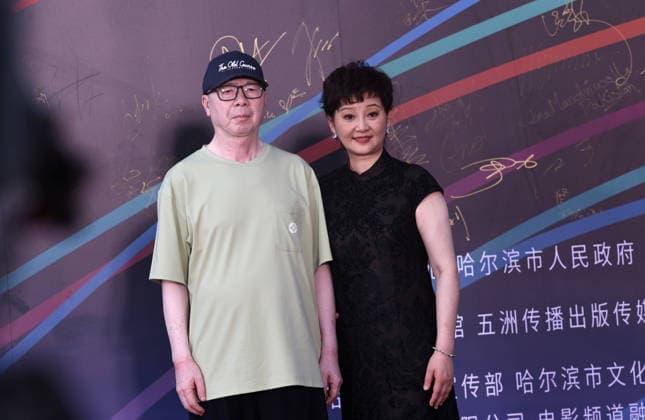 HARBIN, CHINA - AUGUST 12: Director Feng Xiaogang and his wife Xu Fan attend the red carpet ceremony for the closing event of the 7th Jackie Chan Action Film Week on August 12, 2026 in Harbin, Heilongjiang Province of China. The event gathered hundreds of filmmakers to celebrate action cinema.  Copyright: xVCGx 111659586588