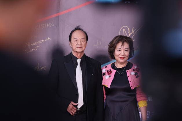 HARBIN, CHINA - AUGUST 12: Actor Ti Lung and his wife attend the red carpet ceremony for the closing event of the 7th Jackie Chan International Action Film Week on August 12, 2026 in Harbin, Heilongjiang Province of China. The film week aims to honor action cinema and filmmakers from around the world.  Copyright: xVCGx 111659586590