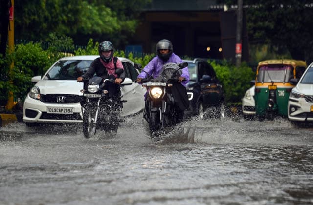 Heavy rain lashes parts of the National Capital New Delhi, Aug 13 (ANI): Commuters wade through a waterlogged road following heavy rainfall, in New Delhi on Thursday. New Delhi Delhi India Copyright: xANIx ANI_20260813258