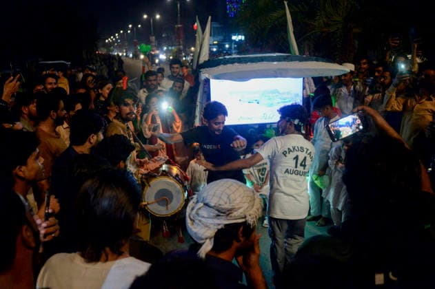 Pakistan Independence Day Celebrations Rawalpindi A crowd gathers around a small vehicle as a drummer performs during Independence Day celebrations in Rawalpindi, Pakistan, on August 14, 2026. Pakistan marks Independence Day on August 14, commemorating the countryis independence from British rule in 1947. Rawalpindi Punjab Pakistan Copyright: xZubairxAbbasix