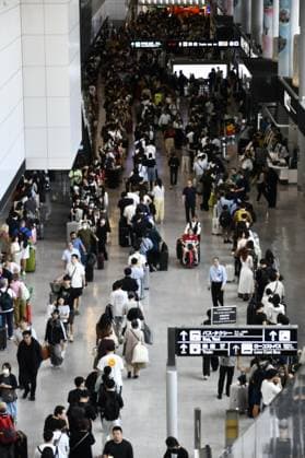Aftermath of torrential rain in eastern Japan Travelers stand in long lines to board public transportation at Narita airport in Chiba Prefecture, east of Tokyo, on Aug. 14, 2026, after being stranded there overnight by torrential rain. Japan s weather agency issued its highest Level 5 warning for downpours in parts of the prefecture.  A14AA0005625749P