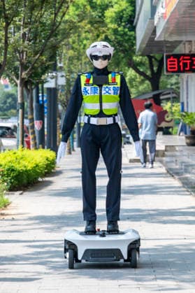 YONGKANG, CHINA - AUGUST 14: A robot traffic police officer moves toward an intersection to begin trial duty on August 14, 2026 in Yongkang, Jinhua, Zhejiang Province of China. Local authorities have launched a trial operation of robot traffic police to assist with road safety management.  Copyright: xVCGx 111659918432