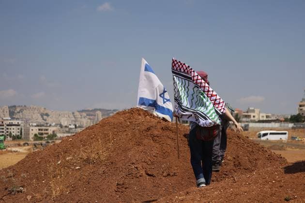 Activists remove Israeli flags from Palestinian home in Beit Sahour BEIT SAHOUR, WEST BANK, PALESTINE, AUGUST 14, 2026: Palestinian and Israeli activists remove an Israeli Star of David and Israeli flags from a Palestinian home in Beit Sahour, east of Bethlehem. The activists said the flags and emblem had been placed on the house by Israeli settlers since October 7, 2023, in what they described as an attempt to take control of the property. According to the activists, settlers arrived at the site as the flags were being removed and opened fire in their direction. No injuries were reported. BEIT SAHOUR Palestine, State of Copyright: x xMosabxshawerx xJNAxPressx