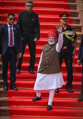 NEW DELHI, INDIA - AUGUST 15: Prime Minister Narendra Modi greets people at the Red Fort on 80th Independence Day on August 15, 2026 in New Delhi, India. For the first time, the national song, Vande Mataram , was rendered during the celebrations at the Red Fort. The National Anthem rendition was synchronised with the 21-gun salute by the gunners of the 1721 Field Battery (Ceremonial), utilising the indigenous 105mm Light Field Guns. PM Modi announced a nationwide initiative to provide free online coaching for competitive exams during his Independence Day address on August 15, 2026. The scheme aims to leverage India s digital infrastructure and top educators to ease the heavy financial burden private coaching hubs place on poor and middle-c