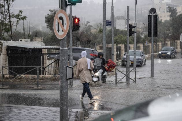 Flash floods submerge vehicles in East Jerusalem neighborhood following heavy rainfall EAST JERUSALEM - AUGUST 15: People wade through flooded roads and submerged vehicles are seen in the Wadi al-Joz neighborhood of East Jerusalem on August 15, 2026, after unseasonal heavy rainfall triggered localized flash flooding across the area. Search and rescue teams were dispatched to the district as rising waters trapped cars, disrupted traffic flow, and damaged infrastructure across low-lying urban streets. Mostafa Alkharouf Anadolu Jerusalem Israel. Editorial use only. Please get in touch for any other usage.  Copyright: x2026xAnadoluxMostafaxAlkharoufx