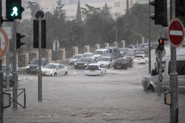 Flash floods submerge vehicles in East Jerusalem neighborhood following heavy rainfall EAST JERUSALEM - AUGUST 15: People wade through flooded roads and submerged vehicles are seen in the Wadi al-Joz neighborhood of East Jerusalem on August 15, 2026, after unseasonal heavy rainfall triggered localized flash flooding across the area. Search and rescue teams were dispatched to the district as rising waters trapped cars, disrupted traffic flow, and damaged infrastructure across low-lying urban streets. Mostafa Alkharouf Anadolu Jerusalem Israel. Editorial use only. Please get in touch for any other usage.  Copyright: x2026xAnadoluxMostafaxAlkharoufx