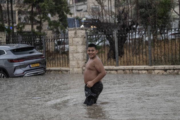 Flash floods submerge vehicles in East Jerusalem neighborhood following heavy rainfall EAST JERUSALEM - AUGUST 15: People wade through flooded roads and submerged vehicles are seen in the Wadi al-Joz neighborhood of East Jerusalem on August 15, 2026, after unseasonal heavy rainfall triggered localized flash flooding across the area. Search and rescue teams were dispatched to the district as rising waters trapped cars, disrupted traffic flow, and damaged infrastructure across low-lying urban streets. Mostafa Alkharouf Anadolu Jerusalem Israel. Editorial use only. Please get in touch for any other usage.  Copyright: x2026xAnadoluxMostafaxAlkharoufx