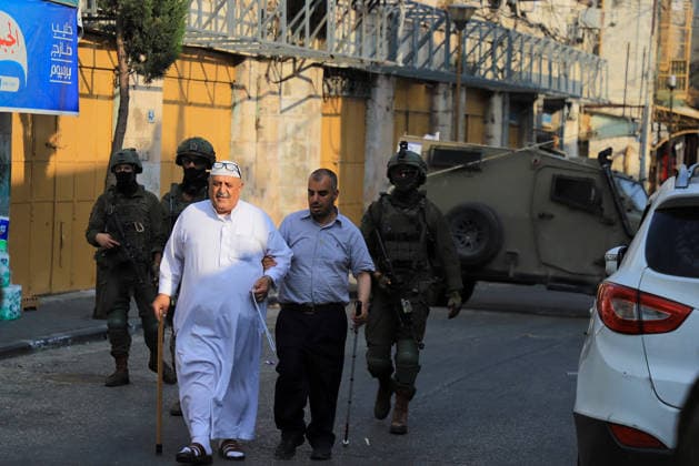 Israeli settlers raid historic Old City of Hebron in West Bank under military escort HEBRON, WEST BANK, PALESTINE - AUGUST 15: Israeli military personnel restrict the movement of local Palestinians during a raid by Israeli settlers in the Old City of Hebron, located in the southern West Bank, Palestine on August 15, 2026. Escorted by armed Israeli forces, the settlers entered the historic district while soldiers blocked key entry and exit points, severely limiting the daily mobility and access of Palestinian residents living in the area. Amer Shallodi Anadolu Hebron West Bank. Editorial use only. Please get in touch for any other usage.  Copyright: x2026xAnadoluxAmerxShallodix