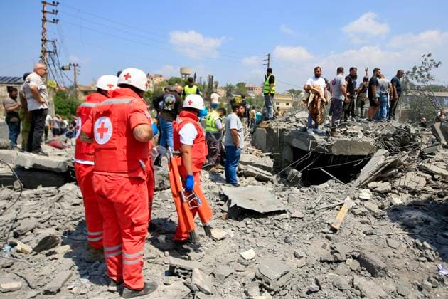(260815) -- DEIR AL ZAHRANI, Aug. 15, 2026 -- Rescuers search through the rubble of buildings hit by Israeli airstrikes in Deir Al Zahrani, southern Lebanon, Aug. 15, 2026. Lebanese broadcaster Al-Jadeed TV reported that four people were killed and nine others wounded after an Israeli airstrike hit a two-story building in the town of Deir Al Zahrani in the Nabatieh District. (Photo by Xinhua) LEBANON-DEIR AL ZAHRANI-ISRAELI AIRSTRIKE AlixHashisho 