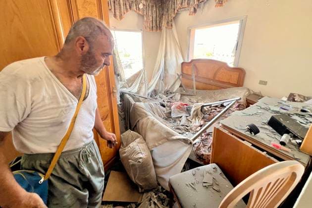 (260815) -- DEIR AL ZAHRANI, Aug. 15, 2026 -- A man inspects his house after an Israeli strike on a nearby building in Deir Al Zahrani, southern Lebanon, Aug. 15, 2026. Lebanese broadcaster Al-Jadeed TV reported that four people were killed and nine others wounded after an Israeli airstrike hit a two-story building in the town of Deir Al Zahrani in the Nabatieh District. (Photo by Xinhua) LEBANON-DEIR AL ZAHRANI-ISRAELI AIRSTRIKE AlixHashisho 