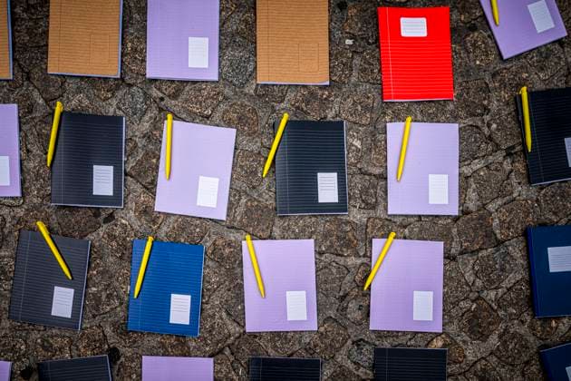 August 15, 2026, Amsterdam, North Holland, The Netherlands Holland: Notebooks and pens are set out as a call for education freedom in Afghanistan. August 15, 2026, Amsterdam, The Netherlands. Demonstrators gathered on Dam Square, Amsterdam, in solidarity with Afghan women and girls. The protest marked five years of Taliban rule and demanded access to education for women and girls be restored, and an end to Brussels engagement with the Taliban regime. Amsterdam The Netherlands Holland - ZUMAp202 20260815_zip_p202_017 Copyright: xJamesxPetermeierx