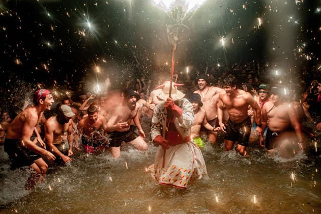 August 15, 2026, Badalona, Spain: People react as a Correfoc devil enters the sea during the August Festival in Badalona, north of Barcelona. The Correfoc, a traditional Catalan celebration featuring fireworks and fire-spitting performers, ends in the waters of Badalona beach. Badalona Spain - ZUMAb137 20260815_fap_b137_001 Copyright: xJordixBoixareux