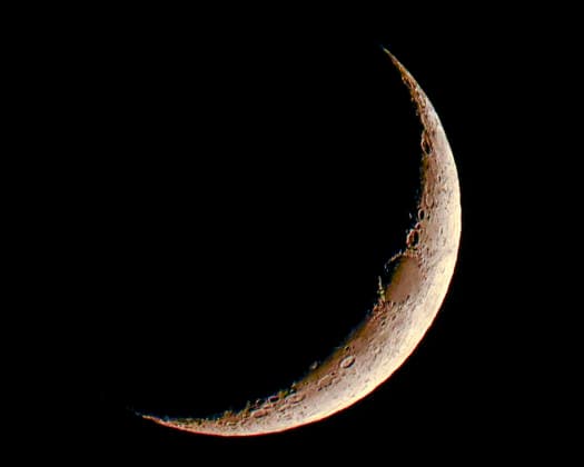 A crescent moon hung low in the sky after the SpaceX Falcon 9 rocket launched eight satellites for GLobalstar at 9:12 PM from Launch Complex 40 at the Cape Canaveral Space Force Station, Florida on Saturday August 15, 2026. The mission classified as Globalstar 2R Launch 1 consisted of a payload of communications satellites for Globalstar and were boosted into low earth orbit.  CCP20260815006 JOExMARINO