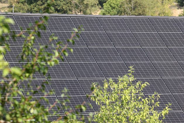 Residential Construction, Home Building in the Siegerland Region A new building is being constructed in a neighborhood of Siegen. Photovoltaic panels and solar collectors have been installed on the roof. Living in the Siegerland Region on August 16, 2026, in Siegen, Germany