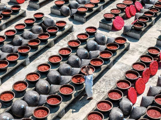 (260816) -- SHUANGFENG, Aug. 16, 2026 -- An aerial drone photo taken on Aug. 16, 2026 shows a staff member operating at an airing field for chili sauce in Yongfeng Subdistrict of Shuangfeng County, Loudi City of central China s Hunan Province. As one of China s protected geographical indication products, chili sauce made in Yongfeng Subdistrict boasts a history of several centuries. (Photo by Xinhua) CHINA-HUNAN-SHUANGFENG-CHILI SAUCE-PREPARATION (CN) LixJianxin 