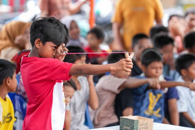 August 16, 2026, Banda Aceh, Aceh, Indonesia: A boy focuses on aiming at a target during a slingshot competition held to celebrate Indonesia s 81st Independence Day in Banda Aceh, Aceh Province, Indonesia, on Sunday. Residents organized various traditional competitions to foster a sense of togetherness and entertain the local community in celebration of Independence Day. Banda Aceh Indonesia - ZUMAi115 20260816_zip_i115_010 Copyright: xMuhammadxIqbalx