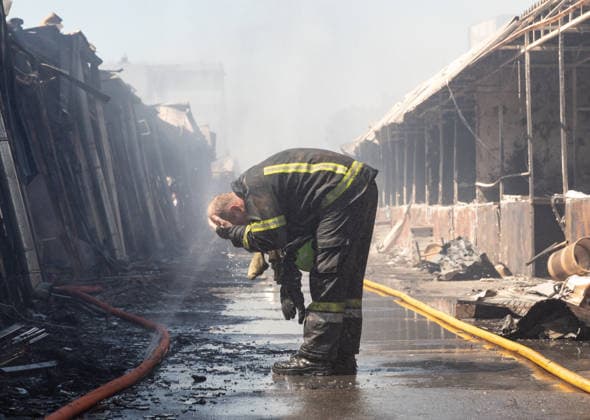 August 16, 2026, Kyiv, Ukraine: A firefighter seen drinking water from a hose amidst the ruins of the Pochayna book market following a Russian attack .. On the night of August 16, 2026, a massive Russian air strike on Kyiv caused severe destruction and a large-scale fire at the Pochaina book market (formerly known as Petrivka) in the Obolon district. The enemy attack completely burned down several rows of trading pavilions containing books and stationery just ahead of the new school year. Emergency response teams worked at the scene to extinguish the blaze, which spread across a vast area. According to preliminary reports from city authorities, at least three people were injured as a result of the overnight attack. The destroyed marketp - ZUMAs197 20260816_aaa_s197_147 Copyright: xMykhayloxPalinchakx