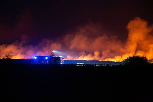 August 16, 2026, Merthyr Tydfil, GB: MERTHYR TYDFIL, WALES, UK, AUGUST 16, 2026: Firefighters from South Wales Fire and Rescue Service battle a wildfire near Dowlais Top as flames approach the Heads of the Valleys road in Merthyr Tydfil, Wales. The wildfire comes after an extended period of hot and dry weather across the United Kingdom. Merthyr Tydfil GB - ZUMAq101 20260816_zna_q101_080 Copyright: xEthanxFowlerx