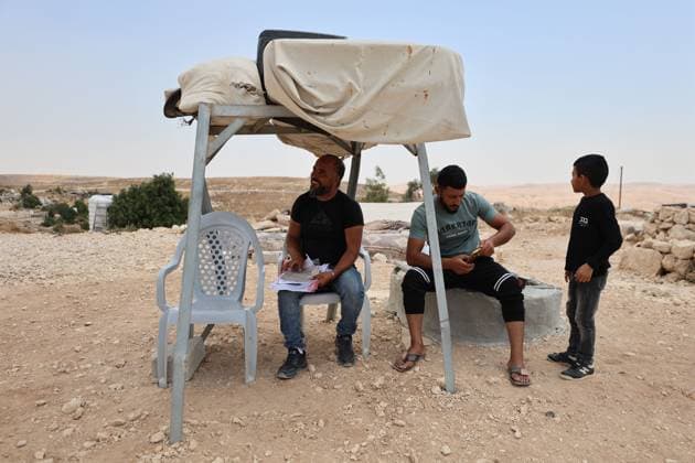 August 16, 2026, Masafer Yatta, Palestine, State of: MASAFER YATTA, WEST BANK, PALESTINE, AUGUST 16, 2026: Palestinian Abdullah Dababseh holds his phone displaying a demolition order issued by the Israeli army for the cave where he lives in Khirbet Khallet Al-Dabaa, south of Hebron. According to local residents, demolition orders were issued for three homes, three caves, a school, trees and crops in the area. Residents said the village was demolished in May 2025, forcing some Palestinians to live in caves. Masafer Yatta Palestine, State of - ZUMAq101 20260816_zna_q101_101 Copyright: xMosabxShawerx