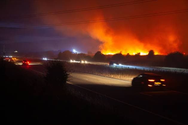 August 16, 2026, Merthyr Tydfil, United Kingdom: Firefighters from South Wales Fire and Rescue Service battle a wildfire near Dowlais Top as flames approach the Heads of the Valleys road in Merthyr Tydfil, Wales. The wildfire comes after an extended period of hot and dry weather across the United Kingdom. Merthyr Tydfil United Kingdom  - ZUMAq101 20260816_zna_q101_078 Copyright: xEthanxFowlerx