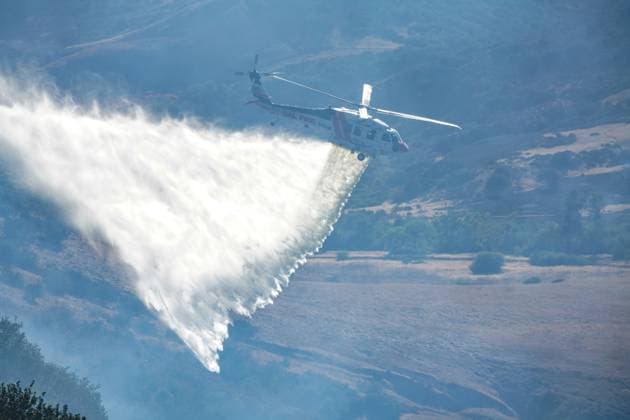 August 16, 2026, San Diego, California, United States: A helicopter drops water during the fire..The Sorrento Fire burns through dry vegetation in the Sorrento Valley area of San Diego on August 16, 2026, sending thick smoke into the air and threatening nearby homes, businesses and roadways. Firefighters work to battle the flames and prevent the fire from spreading as smoke cover portions of the surrounding community. Multiple agencies are dispatched to battle the fire, including Cal Fire and San Diego Fire-Rescue. As of 6pm on August 16, the fire is mapped more than 100 acres. San Diego United States - ZUMAs197 20260816_aaa_s197_239 Copyright: xWaixLeexMichaelxHox