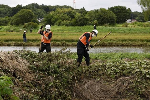 Aftermath of torrential rain in Chiba Police officers search for missing persons near a swollen river in Chiba on Aug. 15, 2026, following the torrential rain that hit the eastern Japan prefecture on Aug. 13.  A14AA0005626009P