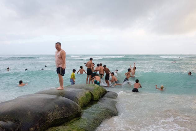 August 16, 2026, Honolulu, Hawaii, USA: Tropical storm LalaÃ¢â‚¬â ¢s worst affected Oahu and Waikiki beginning after 1:00 a.m. Sunday August 16, 2026 and lasted, tapering, through mid-afternoon leaving behind flooding, downed trees, and more than 130,000 Hawaiian Electric customers without power at 4:00 p.m. But at sunset Waikiki Beach was packed with people taking advantage of a brief respite from the rain that the National Weather Service forecasts will last through the week as the slow-moving storm moves Northwest beneath the Hawaiian archipelago. Schools, government offices and many businesses will remain closed on Monday as people on OÃ¢â‚¬Ëœahu sort through the stormÃ¢â‚¬â ¢s consequences. Kids play on a burrito erosion prevention - ZUMAm255 20260816_znp_m255_002 Copyright: xJ.xMattx