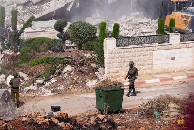 Israeli forces demolish two-story Palestinian house in East Jerusalem EAST JERUSALEM - AUGUST 17: Israeli soldiers take security measures as a two-story Palestinian-owned home is demolished in Qalandiya town, northwest of East Jerusalem, on August 17, 2026. The demolition carried out by Israeli forces left at least 15 Palestinians homeless. Issam Rimawi Anadolu Jerusalem Israel. Editorial use only. Please get in touch for any other usage.  Copyright: x2026xAnadoluxIssamxRimawix