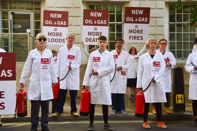 August 17, 2026, London, England, United Kingdom: Climate activists from the group Scientists On Survival stand outside the Department for Energy Security and Net Zero (DESNZ) in Westminster with placards and fire extinguishers after spraying the building with water in protest against Rosebank, as the public consulation on the North Sea oil and gas field concludes. London United Kingdom - ZUMAv130 20260817_zip_v130_010 Copyright: xVukxValcicx