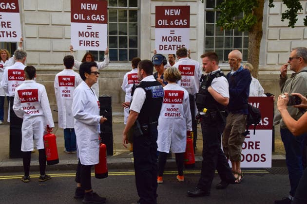 August 17, 2026, London, England, United Kingdom: Police officers speak to climate activists from the group Scientists On Survival outside the Department for Energy Security and Net Zero (DESNZ) in Westminster after they sprayed the building with water using fire extinguishers in protest against Rosebank, as the public consulation on the North Sea oil and gas field concludes. London United Kingdom - ZUMAv130 20260817_zip_v130_027 Copyright: xVukxValcicx