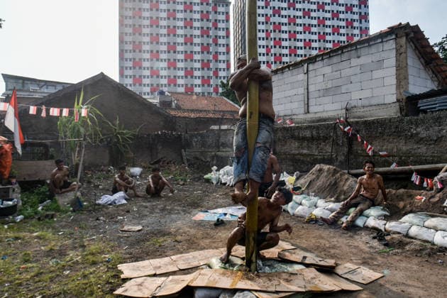 August 17, 2026, Bandung Regency, West Java, Indonesia: Participants climb a pole coated in oil and mud, with prizes placed at the top, during a competition locally known as Panjat Pinang to commemorate the 81st anniversary of the Republic of Indonesia s independence in Lengkong Village, Bandung Regency, Indonesia. Bandung Regency Indonesia - ZUMAr272 20260817_zip_r272_018 Copyright: xDimasxRachmatsyahx