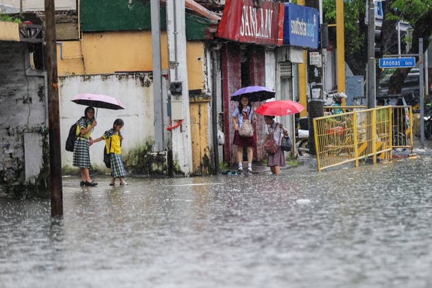 (260817) -- QUEZON CITY, Aug. 17, 2026 -- People wade through floodwater in Quezon City, the Philippines, on Aug. 17, 2026. The Philippine government has suspended in-person classes in Metro Manila and 12 other provinces as heavy rains from tropical cyclones and the southwest monsoon continue to batter the country, local media reported on Monday. The extreme rainfall has triggered severe flooding and landslides across the nation. The well-known flood-control corruption scandal has left key infrastructure unfinished or poorly maintained, further straining the country s disaster response, local media reported. ) THE PHILIPPINES-QUEZON CITY-SOUTHWEST MONSOON-FLOOD RouellexUmali 