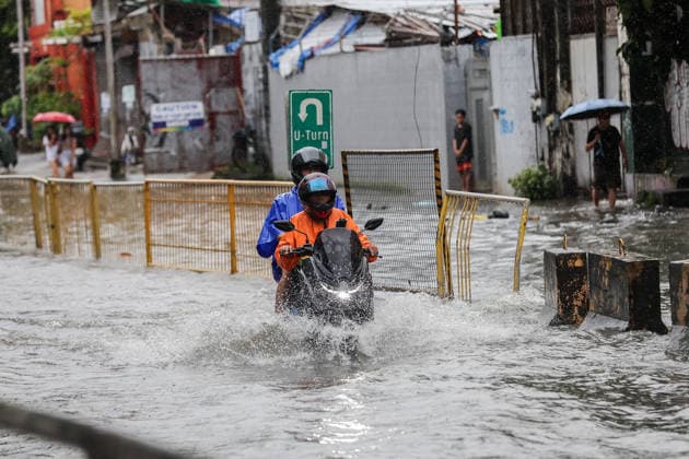 (260817) -- QUEZON CITY, Aug. 17, 2026 -- People ride a motorcycle through floodwater in Quezon City, the Philippines, on Aug. 17, 2026. The Philippine government has suspended in-person classes in Metro Manila and 12 other provinces as heavy rains from tropical cyclones and the southwest monsoon continue to batter the country, local media reported on Monday. The extreme rainfall has triggered severe flooding and landslides across the nation. The well-known flood-control corruption scandal has left key infrastructure unfinished or poorly maintained, further straining the country s disaster response, local media reported. ) THE PHILIPPINES-QUEZON CITY-SOUTHWEST MONSOON-FLOOD RouellexUmali 