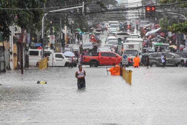 (260817) -- QUEZON CITY, Aug. 17, 2026 -- A man wades through floodwater in Quezon City, the Philippines, on Aug. 17, 2026. The Philippine government has suspended in-person classes in Metro Manila and 12 other provinces as heavy rains from tropical cyclones and the southwest monsoon continue to batter the country, local media reported on Monday. The extreme rainfall has triggered severe flooding and landslides across the nation. The well-known flood-control corruption scandal has left key infrastructure unfinished or poorly maintained, further straining the country s disaster response, local media reported. ) THE PHILIPPINES-QUEZON CITY-SOUTHWEST MONSOON-FLOOD RouellexUmali 