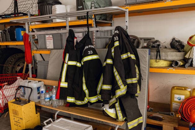 Lecornu Visits Fire-Hit Area As Residents Seek Aid - Le Porge Firefighting gear from the Sapeurs Pompiers 33 unit is displayed in Le Porge, Gironde, France on August 17, 2026, amid a gathering of wildfire victims dressed in black who had hoped to meet French Prime Minister Sebastien Lecornu after the meeting location was moved from the town hall to the fire station. Photo by Gardelle M ANDBZ ABACAPRESS.COM Le Porge Nouvelle-Aquitaine France  Copyright: xANDBZ ABACAx