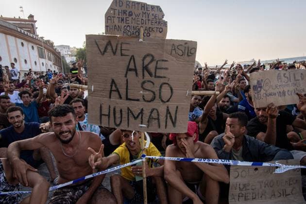 August 17, 2026, Ceuta, Spain: CEUTA, SPAIN Ã¢â‚¬ AUGUST 17, 2026: More than 100 migrants, most of them Moroccan, have been protesting for days in front of National Police vans during the daily food distribution provided by the Spanish Red Cross at TrampoloÂ­n Beach. Ã¢â‚¬oeNo asylum, no foodÃ¢â‚¬Â is the chant repeated by the migrants on the sand, while African migrants continue to stay in the temporary accommodation facilities set up on the Ceuta beach. Authorities are expected to clear the beach in the coming days and transfer the migrants to four reception facilities announced today by SpainÃ¢â‚¬â ¢s Minister for Migration, Elma Saiz. Ceuta Spain - ZUMAq101 20260817_zna_q101_080 Copyright: xAntonioxSemperex