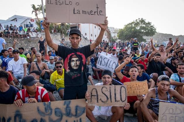 August 17, 2026, Ceuta, Spain: CEUTA, SPAIN Ã¢â‚¬ AUGUST 17, 2026: More than 100 migrants, most of them Moroccan, have been protesting for days in front of National Police vans during the daily food distribution provided by the Spanish Red Cross at TrampoloÂ­n Beach. Ã¢â‚¬oeNo asylum, no foodÃ¢â‚¬Â is the chant repeated by the migrants on the sand, while African migrants continue to stay in the temporary accommodation facilities set up on the Ceuta beach. Authorities are expected to clear the beach in the coming days and transfer the migrants to four reception facilities announced today by SpainÃ¢â‚¬â ¢s Minister for Migration, Elma Saiz. Ceuta Spain  - ZUMAq101 20260817_zna_q101_083 Copyright: xAntonioxSemperex