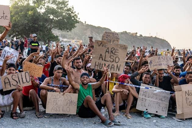 August 17, 2026, Ceuta, Spain: CEUTA, SPAIN Ã¢â‚¬? AUGUST 17, 2026: More than 100 migrants, most of them Moroccan, have been protesting for days in front of National Police vans during the daily food distribution provided by the Spanish Red Cross at TrampoloÂ­n Beach. Ã¢â‚¬oeNo asylum, no foodÃ¢â‚¬Â? is the chant repeated by the migrants on the sand, while African migrants continue to stay in the temporary accommodation facilities set up on the Ceuta beach. Authorities are expected to clear the beach in the coming days and transfer the migrants to four reception facilities announced today by SpainÃ¢â‚¬â ¢s Minister for Migration, Elma Saiz. Ceuta Spain - ZUMAq101 20260817_zna_q101_081 Copyright: xAntonioxSemperex