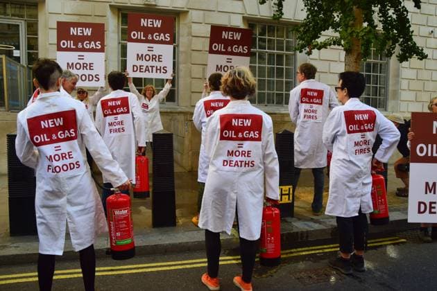 Anti-Rosebank Protests in London, UK - 17 Aug 2026 Climate activists from the group Scientists On Survival wearing lab coats stand with placards and fire extinguishers after spraying the building with water during a protest against Rosebank outside the Department for Energy Security and Net Zero (DESNZ). Two separate groups staged protests in Westminster as the public consultation on the North Sea oil and gas field concludes. London United Kingdom Copyright: xVukxValcicx xSOPAxImagesx Vuk-Valcic-1442823