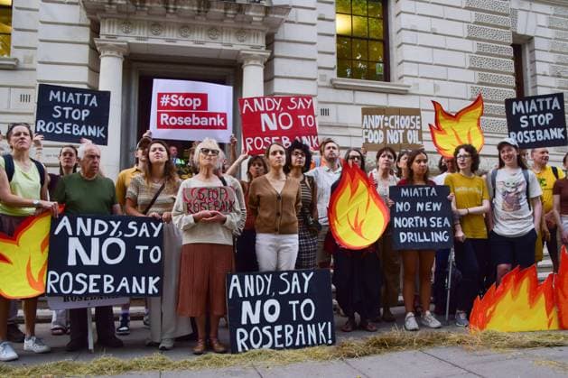 Anti-Rosebank Protests in London, UK - 17 Aug 2026 Climate activists from the group Fossil Free London stand among cardboard flames with placards calling on the UK Prime Minister Andy Burnham and the Energy Secretary Miatta Fahnbulleh to stop Rosebank during a protest against Rosebank outside the Treasury. Two separate groups staged protests in Westminster as the public consultation on the North Sea oil and gas field concludes. London United Kingdom Copyright: xVukxValcicx xSOPAxImagesx Vuk-Valcic-1442846