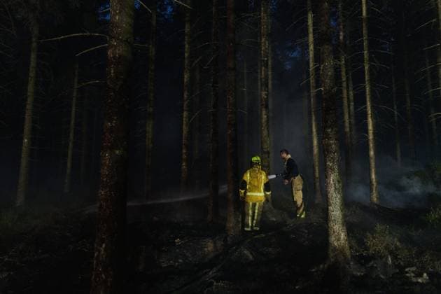 Firefighters pictured in action, as a fire rages in the Hautes Fagnes (High Fens) nature reserve, on Tuesday 18 August 2026. The fire started on August 14th and 2700 hectares (on a total of 4500) are impacted.  NICOLASxLAMBERT 183633703
