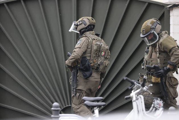 Police seal off Erlenhofstrasse in Cologne after reports of gunshots from attic COLOGNE, GERMANY - AUGUST 18: German police officers secure the cordoned-off perimeter around Erlenhofstrasse during an ongoing armed operation in the Niehl district of Cologne, Germany, on August 18, 2026. Following reports that a man fired gunshots into the air from an attic apartment, numerous police units were dispatched to the scene, shutting down Erlenhofstrasse and surrounding connecting roads to vehicular and pedestrian traffic while urging the public to avoid the area. Kadir Ilboga Anadolu Cologne Germany. Editorial use only. Please get in touch for any other usage.  Copyright: x2026xAnadoluxKadirxIlbogax