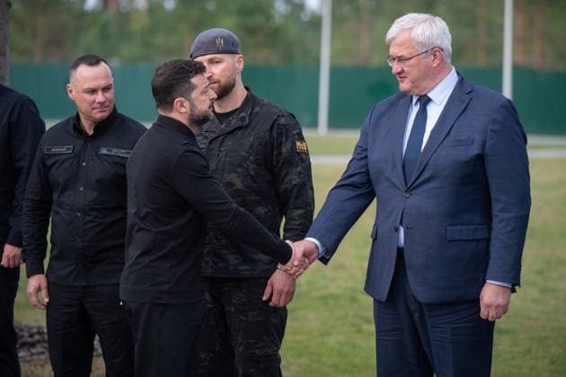 President of Ukraine Volodymyr Zelenskyy (L) shakes hands with Acting Minister of Foreign Affairs of Ukraine Andrii Sybiha in the presence of Minister of Internal Affairs of Ukraine Ivan Vyhivskyi and Acting Minister of Defence of Ukraine Yevhenii Khmara (L to R, back) during the solemn reburial ceremony of Colonel Yevhen Konovalets, first head of the Organisation of Ukrainian Nationalists (OUN) and colonel of the Army of the Ukrainian People’s Republic (UNR), at the National Military Memorial Cemetery in Kyiv region, Ukraine, August 18, 2026. On August 11, 2026, Konovalets’ remains were exhumed at Crooswijk General Cemetery in Rotterdam, the Netherlands, where they had rested since his assassination by a Soviet agent in May 1938. (Photo by  Copyright: xDanyloxAntoniukx