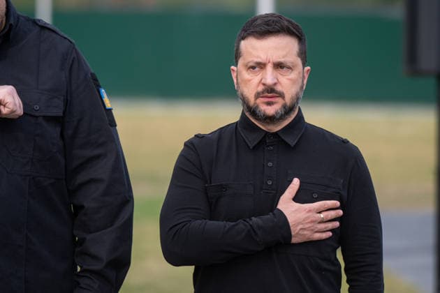 President of Ukraine Volodymyr Zelenskyy presses his hand to his heart during the solemn reburial ceremony of Colonel Yevhen Konovalets, first head of the Organisation of Ukrainian Nationalists (OUN) and colonel of the Army of the Ukrainian People’s Republic (UNR), at the National Military Memorial Cemetery in Kyiv region, Ukraine, August 18, 2026. On August 11, 2026, Konovalets’ remains were exhumed at Crooswijk General Cemetery in Rotterdam, the Netherlands, where they had rested since his assassination by a Soviet agent in May 1938. (Photo by Danylo Antoniuk Ukrinform) Remains of OUN leader Yevhen Konovalets reburied at National Military Memorial Cemetery  Copyright: xDanyloxAntoniukx