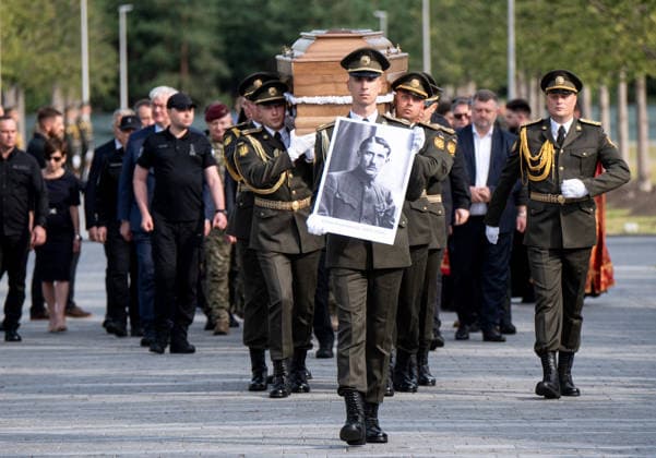 Honour guards of the Ukrainian Armed Forces carry a portrait and the coffin with the remains of Colonel Yevhen Konovalets, first head of the Organisation of Ukrainian Nationalists (OUN) and colonel of the Army of the Ukrainian People’s Republic (UNR), during the solemn reburial ceremony at the National Military Memorial Cemetery in Kyiv region, Ukraine, August 18, 2026. On August 11, 2026, Konovalets’ remains were exhumed at Crooswijk General Cemetery in Rotterdam, the Netherlands, where they had rested since his assassination by a Soviet agent in May 1938. (Photo by Danylo Antoniuk Ukrinform) Remains of OUN leader Yevhen Konovalets reburied at National Military Memorial Cemetery  Copyright: xDanyloxAntoniukx