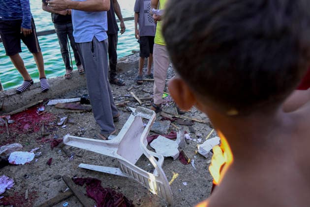 Gaza City Seashore Shelling Palestinians inspect debris following shelling along the seashore in Gaza City, Palestinian Territories on August 18, 2026. At least six Palestinians, including a child, were killed and 10 others injured on Tuesday in an Israeli airstrike that hit a cafe in the seaport area west of Gaza City, according to a medical source. Gaza Gaza Strip Palestinian Territories Copyright: xMohammedxAlxQumsanx