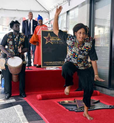 Five-time Grammy-winning Beninese musician, actress, and activist Angelique Kidjo watches dancers perform during an unveiling ceremony honoring her with the 2,854th star on the Hollywood Walk of Fame in Los Angeles on Tuesday, August 18, 2026.  LAP2026081803 JIMxRUYMEN