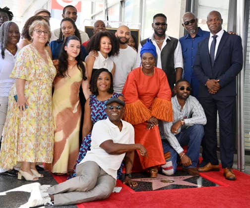 Five-time Grammy-winning Beninese musician, actress, and activist Angelique Kidjo is joined actor Djimon Hounsou (2-R) and other attendees during an unveiling ceremony honoring her with the 2,854th star on the Hollywood Walk of Fame in Los Angeles on Tuesday, August 18, 2026.  LAP2026081826 JIMxRUYMEN