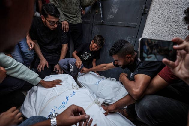 Funeral ceremony for those killed in an Israeli attack on a cafe in Gaza City GAZA CITY, GAZA, PALESTINE - AUGUST 19: Relatives grieve over the bodies of Palestinians, killed in an Israeli drone strike targeting a beachfront cafe in the port area west of Gaza City, during funeral proceedings at Al-Shifa Hospital in Gaza City, Gaza, Palestine on August 19, 2026. At least six Palestinians, including a child, were killed and more than 14 others injured when an Israeli unmanned aerial vehicle (UAV) fired missiles at the crowded cafe, despite calls from U.S. President Donald Trump for Israel to cease attacks in the enclave. Following the completion of funeral rites at the hospital, the victims were taken for burial by their mourning families. Al  Copyright: x2026xAnadoluxAlixJadallahx
